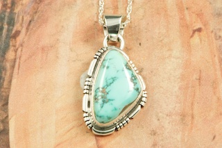 Genuine Blue Moon Turquoise set in Sterling Silver Pendant. The Blue Moon Turquoise Mine is located in Esmeralda County, Nevada. It closed in the late 1970's. Blue Moon Turquoise is now obtained from private collections. Created by Navajo Artist Jake Sampson. Signed by the artist.